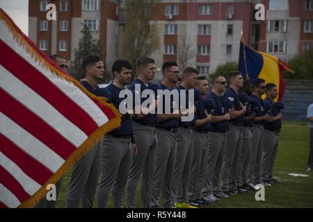 U.S. Marines with the Black Sea Rotational Force 17.1 stand for the National Anthem at the Jackie Robinson Day baseball game between the U.S. Marines and a Romanian team in Constanta, Romania April 15, 2017. The Marine and Romanian players all wore the number 42 jersey in honor of the 70th anniversary of Robinson becoming the first African American player in the Major League Baseball history. Stock Photo