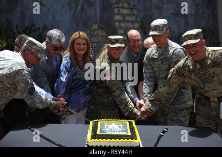 Distinguished guests Honorable Jennifer Gonzalez, Resident Commissioner of Puerto Rico, Maj. Gen. (Ret.) Felix Santoni, Civilian Aide to the Secretary of the Army, Mr. Luis Soto, Civilian Aide to the Secretary of the Army, Brig. Gen. Alberto C. Rosende, 1st Mission Support Command commanding general, Mr. Horacio Cabrera, U.S. Army Reserve Ambassador, and Brig. Gen. (Ret.) Victor Perez along with the youngest Soldier present, Pfc. Michael Rodriguez a firefighter assigned to the 266th OD Company and the oldest Soldier present, Maj. Ramon Pares, historian for the 1st MSC, use ceremonial sabers to Stock Photo