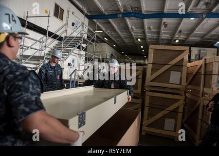 Sailor Make Rack Sailors carry a new berthing rack to an enlisted area aboard USS John C ...