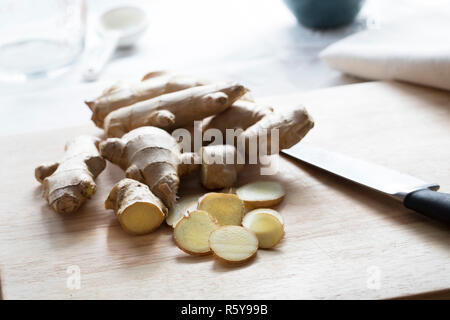 Ginger Slices and Roots with Knife Stock Photo
