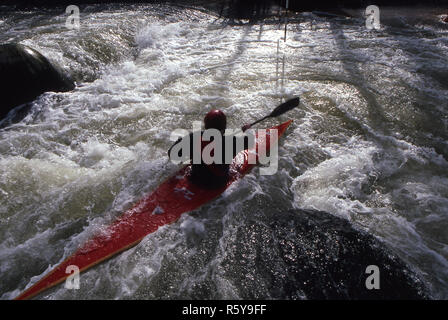 A whitewater kayaker practices on the Dickerson course, in Dickerson, Maryland.  The water of the course is heated by the run off from a nearby power plant. Stock Photo