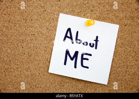 A yellow sticky note writing, caption, inscription Phrase ABOUT ME in black ext on a sticky note pinned to a cork notice board Stock Photo