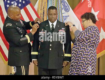 Brig. Gen. David Wilson, Chief of Ordnance, stands at attention while Lt. Gen. Stephen Twitty, commanding general, First Army, Patricia Wilson, his spouse, place brigadier general epaulets on his jack during his promotion ceremony April 13 at the Citadel. Twitty is a longtime mentor to Wilson. Stock Photo