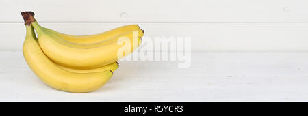 bananas fruit fruits banner copy space on wooden plate Stock Photo