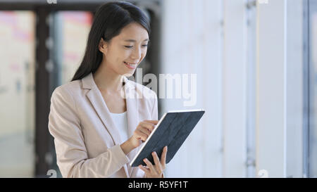 Business woman using tablet in office Stock Photo