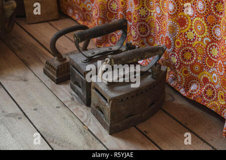 Ancient irons on a timber floor Stock Photo