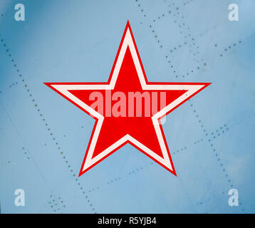 Five-pointed red star on the wing skin of a military fighter Stock Photo