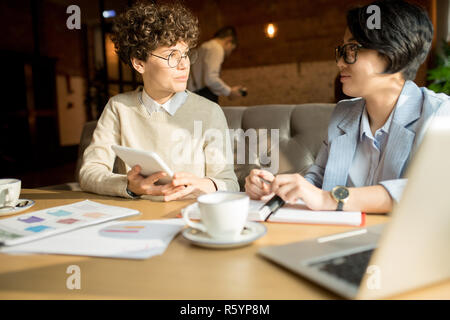 Serious colleagues analyzing data together Stock Photo