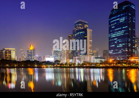 Building city in business area night scene with river reflection in Bangkok, Thailand. Stock Photo