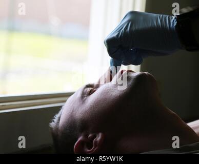 U.S. Army Sgt. Anthony Barba, 184th Headquarters and Headquarters Detachment (EOD), 184th Ordnance Disposal Battalion (EOD), 52nd Ordnance Group (EOD), receives a nasopharyngeal airway at the Yakima Training Center, Wash., April 21, 2017. The CBRNE Leaders Course is designed to create adaptable leaders capable of combating chemical, biological, radiological, nuclear, and explosive hazards in both permissive and non-permissive environments around the world. Stock Photo