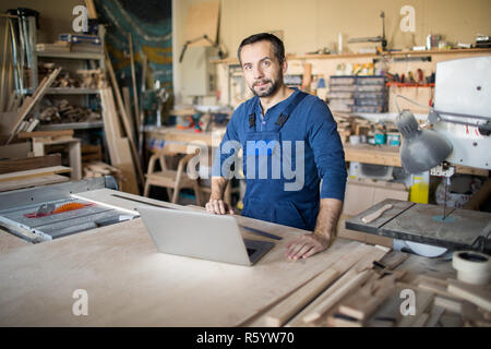 Mature Carpenter Posing in Workshop Stock Photo