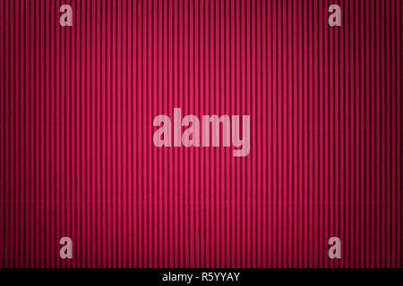 Texture of corrugated dark red paper with vignette, macro. Striped pattern of maroon cardboard background, closeup. Stock Photo
