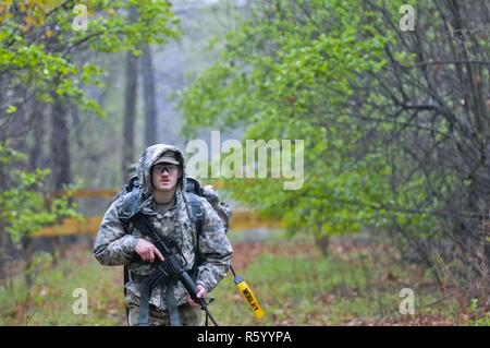 Pfc. Toby Mosley, 428th Mobility Augmentation Company, 397th Engineer Battalion, 372nd Engineer Brigade, 416th Theater Engineer Command searches for markers during the land navigation portion of the Combined Best Warrior Competition at Joint Base McGuire-Dix-Lakehurst, N.J. April 25, 2017. The 14 contestants must orient, plot, read their maps; then move out to find four points within two hours. The Soldiers must earn the title of Best Warrior or Best Noncommissioned Officer to move on to represent the 412th Theater Engineer Command,  416th Theater Engineer Command and 76th Operational Response Stock Photo