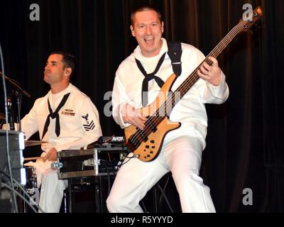 SAN ANTONIO – (April 24, 2017) Virginia Beach, Va. native Musician 1st Class Ross Hartig (drums) and Washington, D.C. native Musician 3rd Class Adam Smolonsky (bass) of “Destroyers”, the popular music group of Navy Band Southwest from San Diego, Ca., perform for students of Winston Churchill High School during Fiesta San Antonio 2017. “Destroyers”, along with Sailors from Navy Recruiting District San Antonio and crew members from the USS San Antonio homeported at Naval Station Norfolk in Norfolk, visited the school to conduct community outreach and spread Navy Awareness as part Fiesta festivit Stock Photo