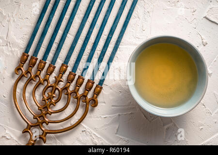 Fragment of Hanukkah and a bowl of olive oil top view Stock Photo