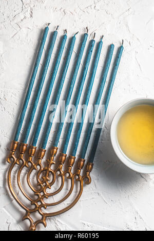 Hanukkah with blue candles and butter in a bowl Stock Photo