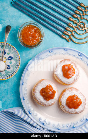 Hanukkah with candles, plates, butter in a bowl and blue napkin top view Stock Photo