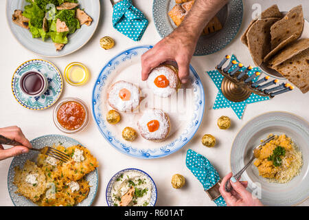 Hanukkah with candles, plates, butter in a bowl and blue napkin top view Stock Photo