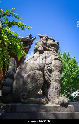 Lion statue in Ushijima Shrine temple, Tokyo, Japan Stock Photo