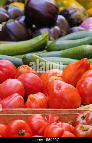 vegetable stand with tomatoes cucumbers eggplant and paprika Stock Photo