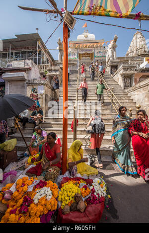 Flowers sellers at the foot or the staircase of Jagdish Temple, Udaipur, Rajasthan, India Stock Photo