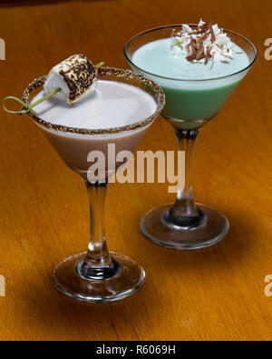 flavorful cocktails on a wooden bar with seasonal ingredients like a s'mores and a grasshopper Stock Photo