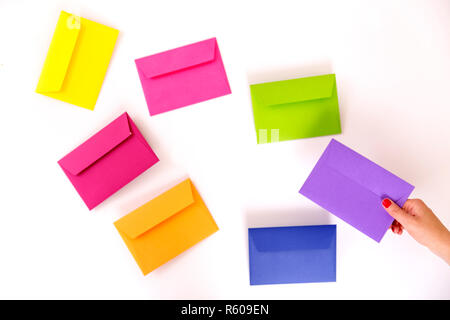Different colored envelopes on the table. Stock Photo