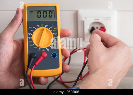 Metering Socket Voltage With Digital Multimeter Stock Photo