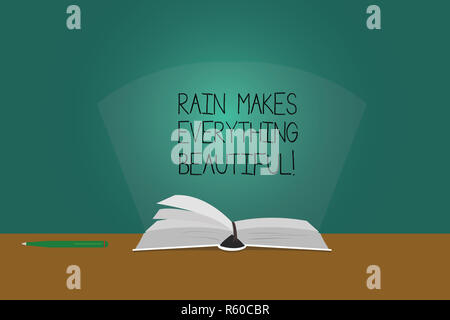 Writing note showing Rain Makes Everything Beautiful. Business photo showcasing Raining convert places in pretty landscapes Color Pages of Book on Tab Stock Photo