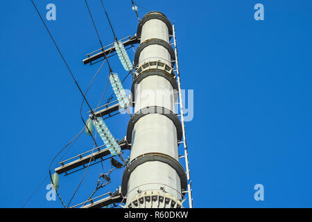 Supports high-voltage power lines against the blue sky Stock Photo