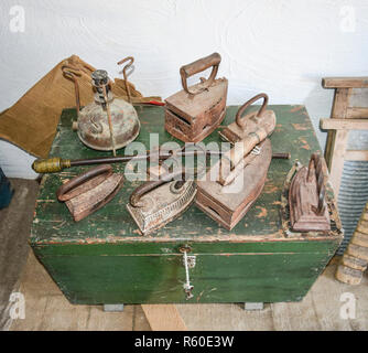 Ancient irons on a timber floor Stock Photo