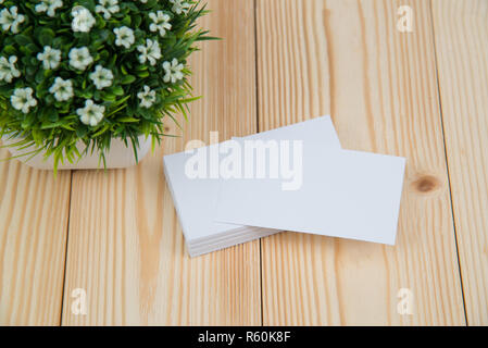 Blank business cards and little decorative tree in white vase on wooden working table with copy space for add text ID. and logo, business company conc Stock Photo