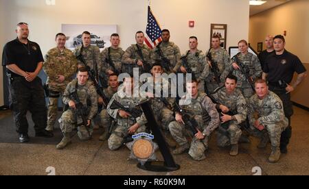 Members from the 460th Security Forces Squadron, the 302nd SFS and Adams County Sheriff Department pose for a group photo Apr. 23, 2017, at the Flatrock Regional Training Center in Commerce City, Colo. Adams County Sheriff Department Special Weapons and Tactics team spent three days training the 460th SFS Emergency Services Team in tactical movements for several possible scenarios. Stock Photo