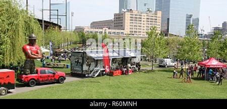 Athletes line up to participate in the Marine Corps pull-up challenge at the 2017 Penn Relays in Philadelphia, Pennsylvania, on April 28. The Marine set-up includes blow-up drill instructors, branded F-150s, tents, pull-up bars, and a special tractor-trailer. Inside the trailer, participants experience Marine Corps training and life through three segments: a brief introduction video by a Marine Corps drill instructor, a weapons handling section that includes multiple M-4 Carbine rifles, and a brief video that explains what the Fleet Marine Force is.  ( Stock Photo