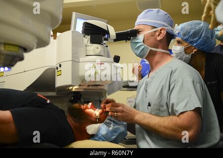 SAN DIEGO (April 24, 2017) Cmdr. John Cason, program director at Navy Refractive Surgery Center, performs a KAMRA corneal inlay procedure for the treatment of presbyopia at the Naval Training Center Medical Branch Clinic. The KAMRA corneal inlay is a mini-ring with an opening in the center that sits in the first few layers of the eye known as the cornea, focusing light coming into the eye restoring near vision. This is the first procedure of this kind done within the Department of Defense. Stock Photo