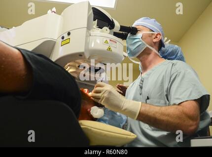 SAN DIEGO (April 24, 2017) Cmdr. John Cason, program director at Navy Refractive Surgery Center, performs a KAMRA corneal inlay procedure for the treatment of presbyopia at the Naval Training Center Medical Branch Clinic. The KAMRA corneal inlay is a mini-ring with an opening in the center that sits in the first few layers of the eye known as the cornea, focusing light coming into the eye restoring near vision. This is the first procedure of this kind done within the Department of Defense. Stock Photo