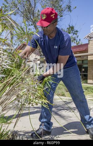 Ret. U.S. Marine Corps Master Sgt. James E. Thrower, operations officer, Marine and Family Programs, performs landscaping maintenance during the 'Weekend of Service' on Camp Pendleton, Calif., April 29, 2017. Community members from surrounding areas volunteered to perform maintenance and gardening projects at several locations across the base as a part of the 'Weekend of Service.' Stock Photo