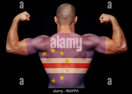 The back of a young sports man wearing a T-shirt with the national flag of Cape Verde on a black isolated background. The concept of national pride an Stock Photo