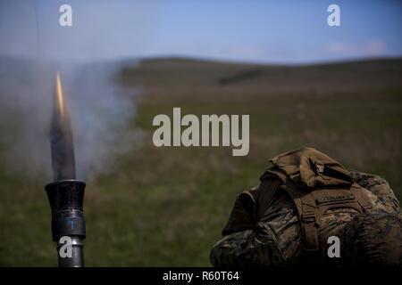 U.S. Marine Cpl. Kyle Campbell, a heavy equipment operator with Black Sea Rotational Force 17.1, fires an 81mm mortar at a live-fire range during Exercise Platinum Eagle 17.2, at Babadag Training Area, Romania, April 27, 2017. Marines from different job fields participated in a live-fire mortar range to gain experience in various Marine Corps weapon systems. With its flexibility and versatility, BSRF is ideally suited to carry out security cooperation efforts and a wide range of other missions. Stock Photo