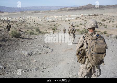 U.S. Marines with Weapons Platoon, Fox Company, 2nd Battalion, 6th Marine Regiment, search for potential improvised explosive devices (IED) while conducting Military Operations in Urban Terrain (MOUT) for Talon Exercise (TalonEx) 2-17, Twentynine Palms, CA., April 27, 2017. The purpose of TalonEx was for ground combat units to conduct integrated training in support of the Weapons and Tactics Instructor Course (WTI) 2-17 hosted by Marine Aviation Weapons and Tactics Squadron One (MAWTS-1). Stock Photo