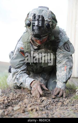 U.S. Army 1st Lt. Josiah Duka, 752nd Ordnance Company (EOD), 79th Ordnance Battalion (EOD), 71st Ordnance Group (EOD), searches for an improvised explosive device at an entryway during a situational training exercise (STX) lane at the Yakima Training Center, Yakima, Wash., April 28, 2017. The final days of the CBRNE Leaders Course are comprised of STX lanes that test what the Soldiers' learned throughout the duration of the course. Stock Photo