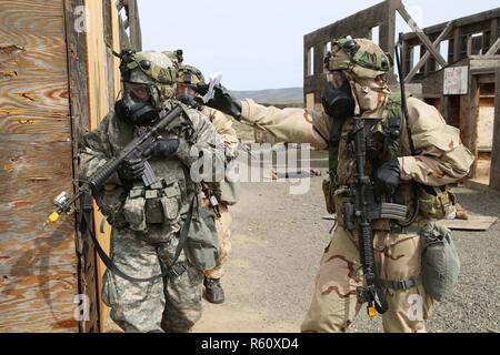 U.S. Army 1st Lt. Thomas Suddes (right), 756th Ordnance Company (EOD), 184th Ordnance Disposal Battalion (EOD), 52nd Ordnance Group (EOD), instructs Sgt. Anthony Barba (left), 184th Headquarters and Headquarters Detachment (EOD), 184th Ordnance Disposal Battalion (EOD), 52nd Ordnance Group (EOD), where to relocate to during a mass casualty situational training exercise (STX) lane at the Yakima Training Center, Yakima, Wash., April 28, 2017. The final days of the CBRNE Leaders Course are comprised of STX lanes that test what the Soldiers' learned throughout the duration of the course. Stock Photo