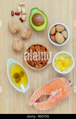 Selection food sources of omega 3 and unsaturated fats. super food high omega 3 and unsaturated fats for healthy food. Almond ,pecan ,hazelnuts,walnuts ,olive oil ,fish oil and avocado . Stock Photo