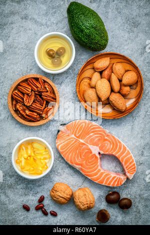 Selection food sources of omega 3 and unsaturated fats. Super food high omega 3 and unsaturated fats for healthy food. Almond ,pecan ,hazelnuts,walnuts ,olive oil ,fish oil ,salmon and avocado . Stock Photo