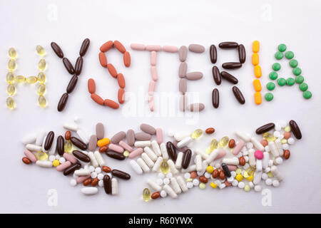 Conceptual Hand writing text caption inspiration Medical care Health concept written with pills drugs capsule word HYSTERIA season On white isolated background with copy space Stock Photo