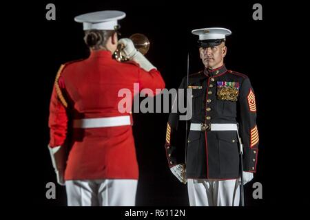 Sergeant Maj. Matthew Hackett, command sergeant major, Marine Barracks Washington D.C., stands at attention while Staff Sgt. Codie Williams, U.S. Marine Drum & Bugle Corps bugler, performs a bugle call during a Friday Evening Parade at the Barracks, May 5, 2017. The guests of honor for the parade were the Honorable Paul Cook, California’s 8th Congressional District Congressman, the Honorable Jack Bergman, Michigan’s 1st Congressional District Congressman, and the Honorable Salud Carbajal, California’s 24th Congressional District Congressman, The hosting official was Gen. Glenn Walters, assista Stock Photo