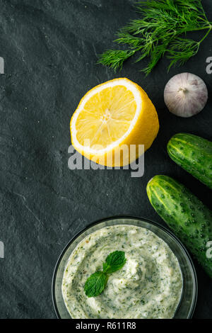 Tzatziki  on the dark stone table with ingredients vertical Stock Photo