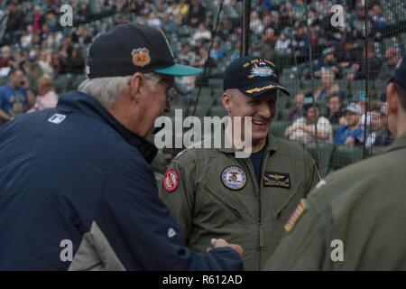 SEATTLE (May 5, 2017) John W. Stanton, chairman and chief executive officer of the Seattle Mariners, talks with Capt. Scott Miller, USS John C. Stennis' (CVN 74) executive officer, and Capt. Greg Huffman, John C. Stennis’ commanding officer, before the ceremonial first pitch at a Mariners baseball game. Huffman threw out the first pitch at Safeco Field as part of “John C. Stennis Family Night” hosted by the Mariners and John C. Stennis’ Morale, Welfare, and Recreation department. John C. Stennis is conducting a planned incremental availability (PIA) at Puget Sound Naval Shipyard and Intermedia Stock Photo