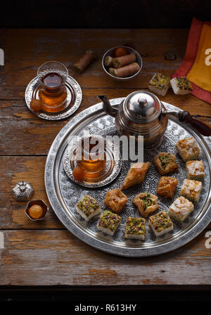 Assorted oriental sweets with tea in traditional cups, copy space Stock Photo