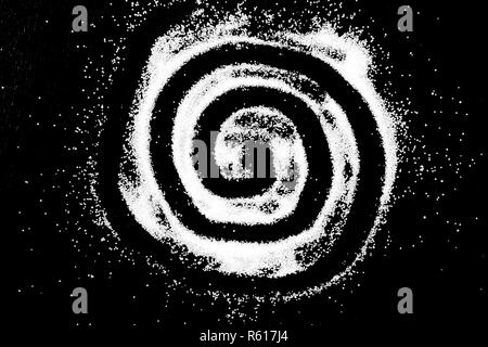 White salt powder circle spiral round cloud on black background. Concept with place for text. Copy space. Stock Photo